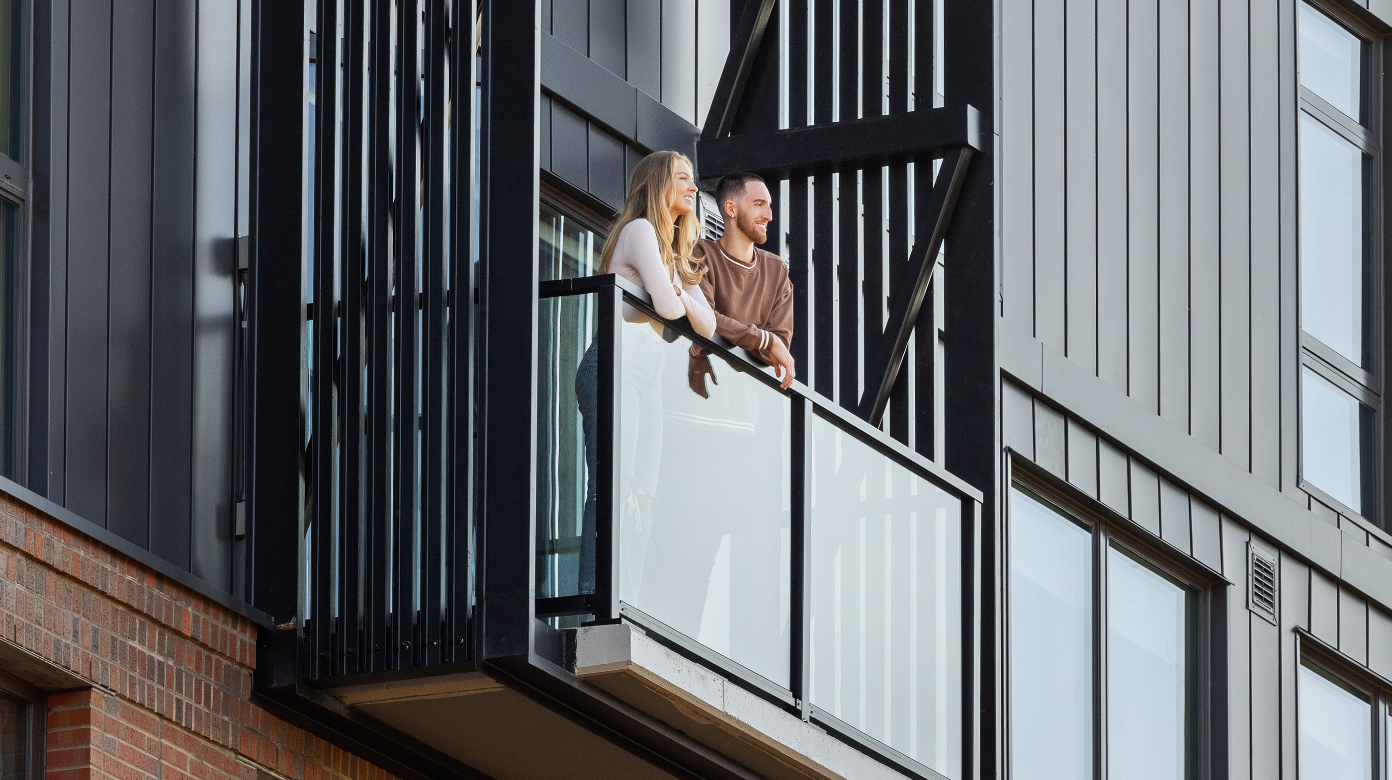 Two young adults on a balcony